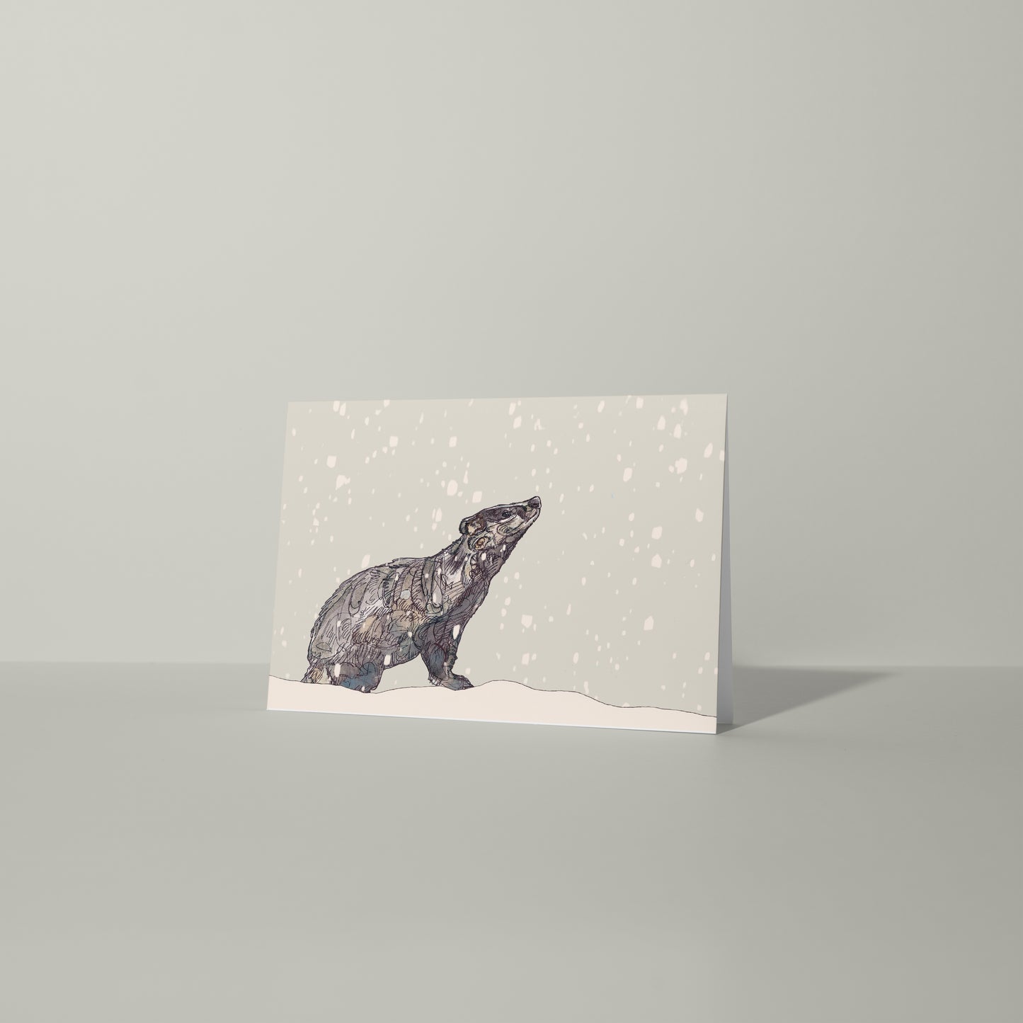 Blank greeting card and envelope badger in the snow christmas card festive winter contemporary illustration animal artist ann pease card art